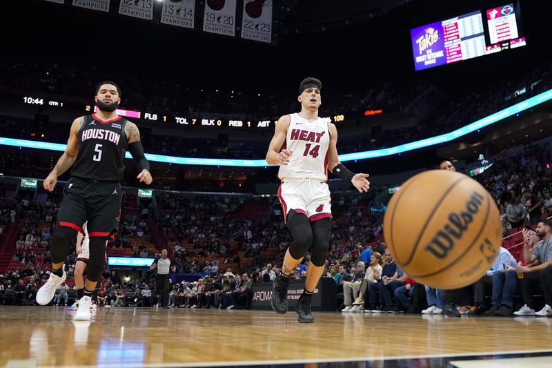 MIAMI, FLORIDA - JANUARY 08: Fred VanVleet #5 of the Houston Rockets and Tyler Herro #14 of the Miami Heat chase a loose ball during a game at Kaseya Center on January 08, 2024 in Miami, Florida. NOTE TO USER: User expressly acknowledges and agrees that, by downloading and or using this photograph, User is consenting to the terms and conditions of the Getty Images License Agreement. (Photo by Rich Storry/Getty Images)