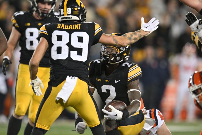 Nov 18, 2023; Iowa City, Iowa, USA; Iowa Hawkeyes running back Kaleb Johnson (2) reacts with wide receiver Nico Ragaini (89) during the fourth quarter against the Illinois Fighting Illini at Kinnick Stadium. Mandatory Credit: Jeffrey Becker-USA TODAY Sports