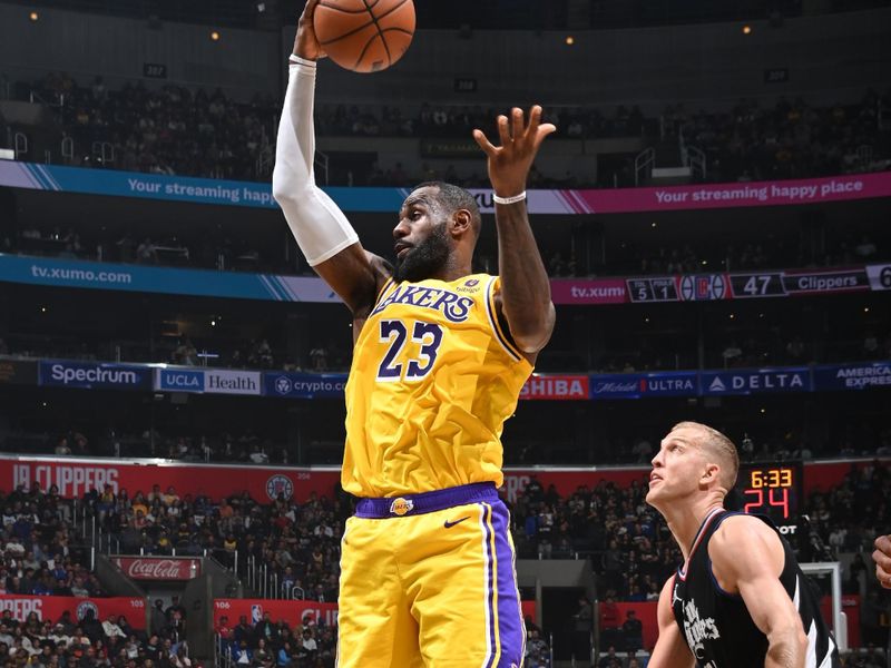 LOS ANGELES, CA - FEBRUARY 28: LeBron James #23 of the Los Angeles Lakers rebounds the ball during the game against the LA Clippers on February 28, 2024 at Crypto.Com Arena in Los Angeles, California. NOTE TO USER: User expressly acknowledges and agrees that, by downloading and/or using this Photograph, user is consenting to the terms and conditions of the Getty Images License Agreement. Mandatory Copyright Notice: Copyright 2024 NBAE (Photo by Andrew D. Bernstein/NBAE via Getty Images)