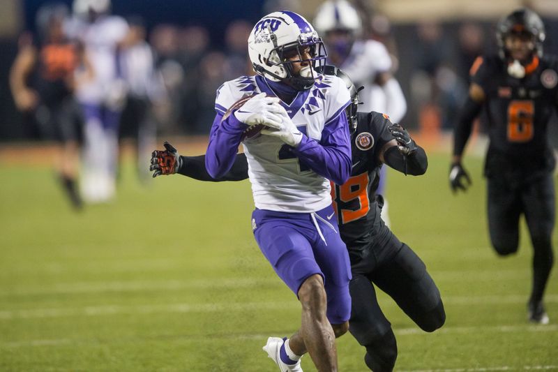 Nov 13, 2021; Stillwater, Oklahoma, USA; TCU Horned Frogs wide receiver Taye Barber (4) runs after a catch and is tackled by Oklahoma State Cowboys safety Trey Rucker (39) during the fourth quarter at Boone Pickens Stadium. Mandatory Credit: Brett Rojo-USA TODAY Sports