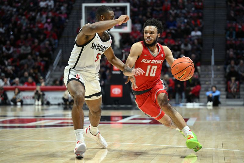 Jan 14, 2023; San Diego, California, USA; New Mexico Lobos guard Jaelen House (10) dribbles the ball while defended by San Diego State Aztecs guard Lamont Butler (5) during the second half at Viejas Arena. Mandatory Credit: Orlando Ramirez-USA TODAY Sports