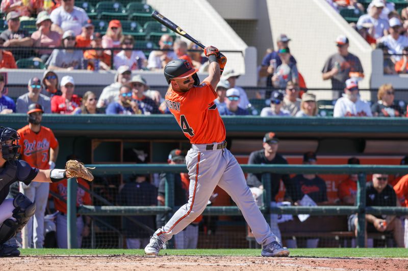 Feb 26, 2023; Lakeland, Florida, USA; Baltimore Orioles second baseman Connor Norby (94) hits a single during the fifth inning against the Detroit Tigers at Publix Field at Joker Marchant Stadium. Mandatory Credit: Mike Watters-USA TODAY Sports