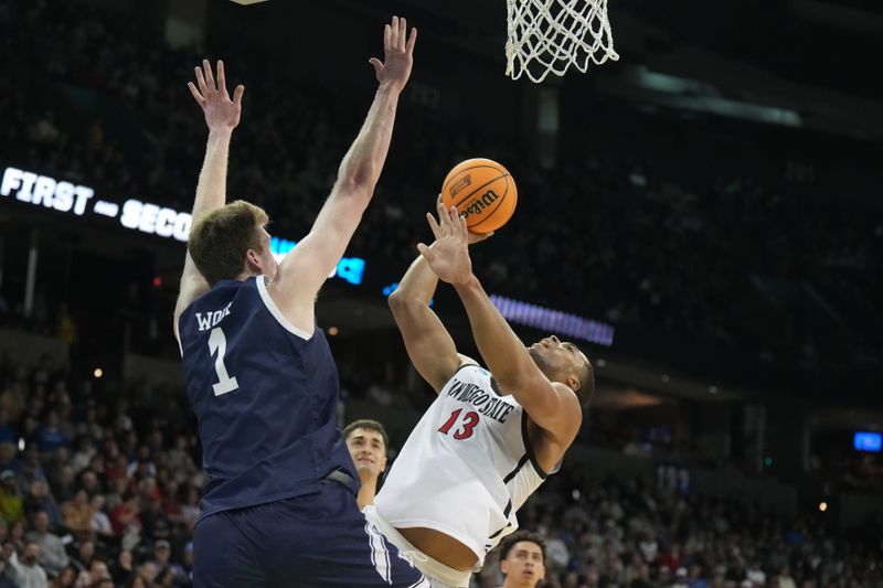 Mar 24, 2024; Spokane, WA, USA; San Diego State Aztecs forward Jaedon LeDee (13) shoots the ball over Yale Bulldogs forward Danny Wolf (1) in the first half at Spokane Veterans Memorial Arena. Mandatory Credit: Kirby Lee-USA TODAY Sports