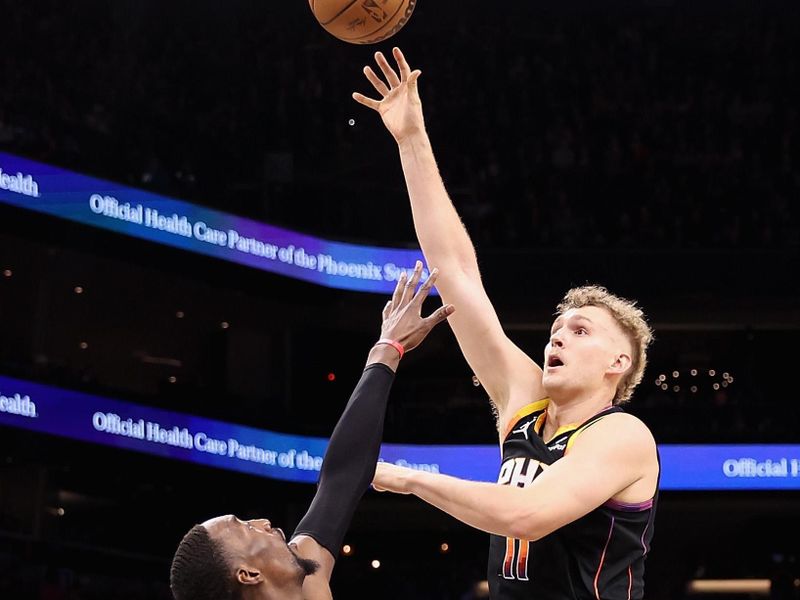 PHOENIX, ARIZONA - JANUARY 06: Jock Landale #11 of the Phoenix Suns puts up a shot over Bam Adebayo #13 of the Miami Heatduring the second half of the NBA game at Footprint Center on January 06, 2023 in Phoenix, Arizona. The Heat defeated the Suns 104-96. NOTE TO USER: User expressly acknowledges and agrees that, by downloading and or using this photograph, User is consenting to the terms and conditions of the Getty Images License Agreement. (Photo by Christian Petersen/Getty Images)