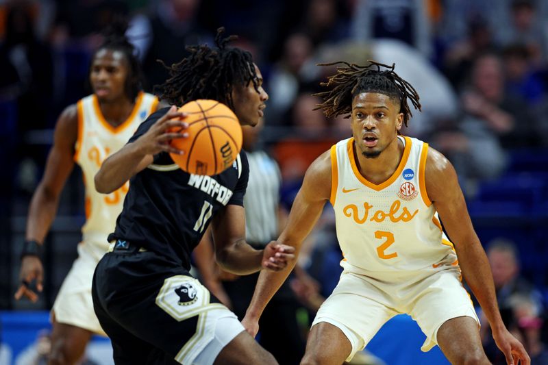 Mar 20, 2025; Lexington, KY, USA; Wofford Terriers guard Kahmare Holmes (11) handles the ball against Tennessee Volunteers guard Chaz Lanier (2) during the first half in the first round of the NCAA Tournament at Rupp Arena. Mandatory Credit: Jordan Prather-Imagn Images