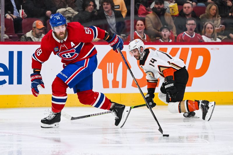 Feb 13, 2024; Montreal, Quebec, CAN; Montreal Canadiens defenseman David Savard (58) plays the puck against Anaheim Ducks center Adam Henrique (14) during the second period at Bell Centre. Mandatory Credit: David Kirouac-USA TODAY Sports