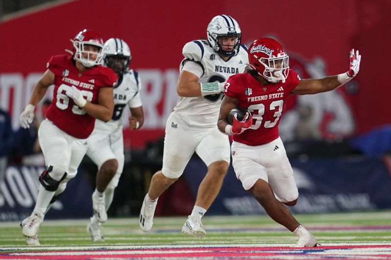 Sep 30, 2023; Fresno, California, USA; Fresno State Bulldogs running back Elijah Gilliam (33) runs the ball against the Nevada Wolf Pack in the fourth quarter at Valley Children's Stadium. Mandatory Credit: Cary Edmondson-USA TODAY Sports