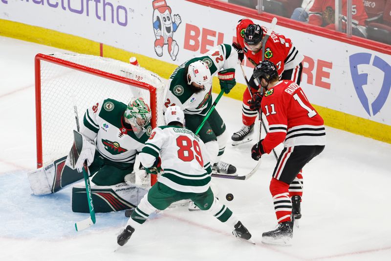 Feb 7, 2024; Chicago, Illinois, USA; Chicago Blackhawks right wing Taylor Raddysh (11) tries to score against the Minnesota Wild during the second period at United Center. Mandatory Credit: Kamil Krzaczynski-USA TODAY Sports