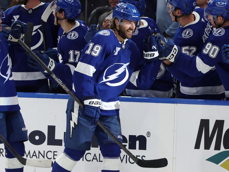 Sep 26, 2025; Tampa, Florida, USA; Tampa Bay Lightning left wing Wojciech Stachowiak (19) is congratulated after he scored a goal against the Carolina Hurricanes during the second period at Benchmark International Arena. Mandatory Credit: Kim Klement Neitzel-Imagn Images