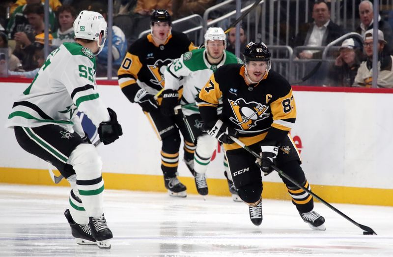 Nov 11, 2024; Pittsburgh, Pennsylvania, USA;  Pittsburgh Penguins center Sidney Crosby (87) skates with the puck as Dallas Stars defenseman Thomas Harley (55) defends during the third period at PPG Paints Arena. Mandatory Credit: Charles LeClaire-Imagn Images