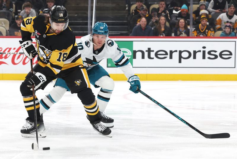 Dec 13, 2025; Pittsburgh, Pennsylvania, USA;  Pittsburgh Penguins center Tommy Novak (18) handles the puck against San Jose Sharks center Ty Dellandrea (10) during the first period at PPG Paints Arena. Mandatory Credit: Charles LeClaire-Imagn Images