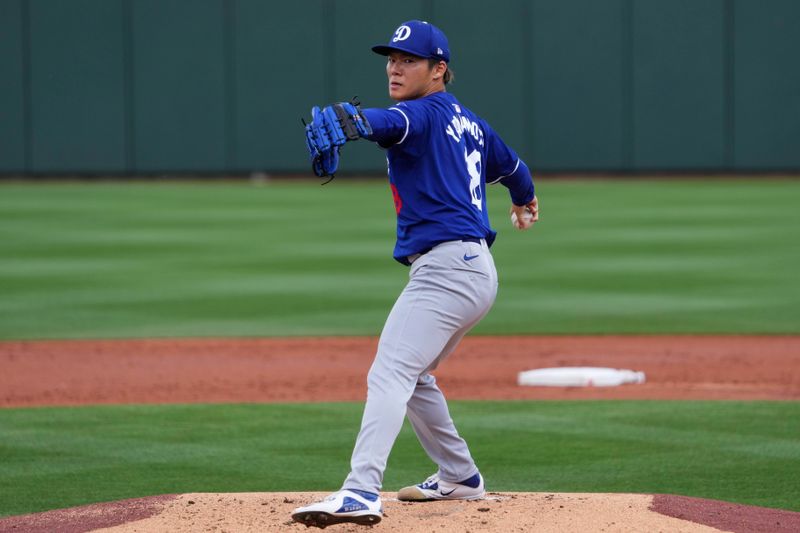 Feb 28, 2024; Surprise, Arizona, USA; Los Angeles Dodgers starting pitcher Yoshinobu Yamamoto (18) pitches during the third inning against the Texas Rangers at Surprise Stadium. Mandatory Credit: Joe Camporeale-USA TODAY Sports