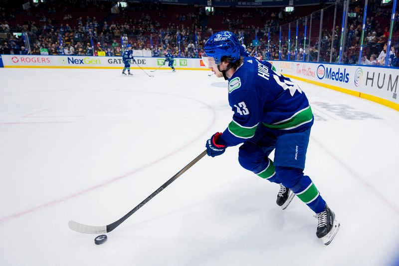 Jan 24, 2024; Vancouver, British Columbia, CAN; Vancouver Canucks defenseman Quinn Hughes (43) handles the puck during warm up prior to a game against the St. Louis Blues at Rogers Arena. Mandatory Credit: Bob Frid-USA TODAY Sports