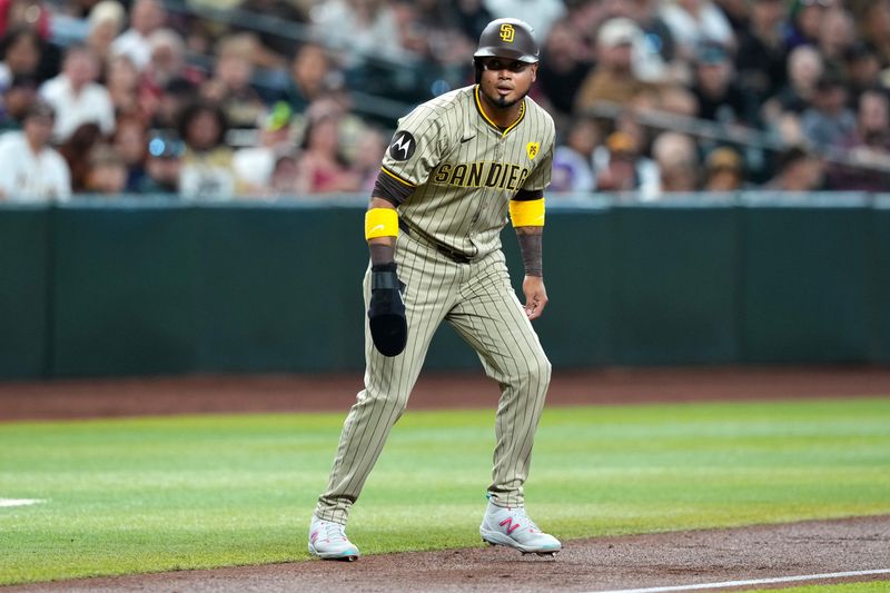 May 4, 2024; Phoenix, Arizona, USA; San Diego Padres designated hitter Luis Arraez (4) leads off third base against the Arizona Diamondbacks against the Arizona Diamondbacks during the first inning at Chase Field. Mandatory Credit: Joe Camporeale-USA TODAY Sports