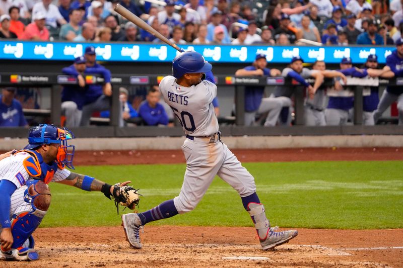 Jul 16, 2023; New York City, New York, USA;  Los Angeles Dodgers second baseman Mookie Betts (50) hits an RBI single against the New York Mets during the eighth inning at Citi Field. Mandatory Credit: Gregory Fisher-USA TODAY Sports