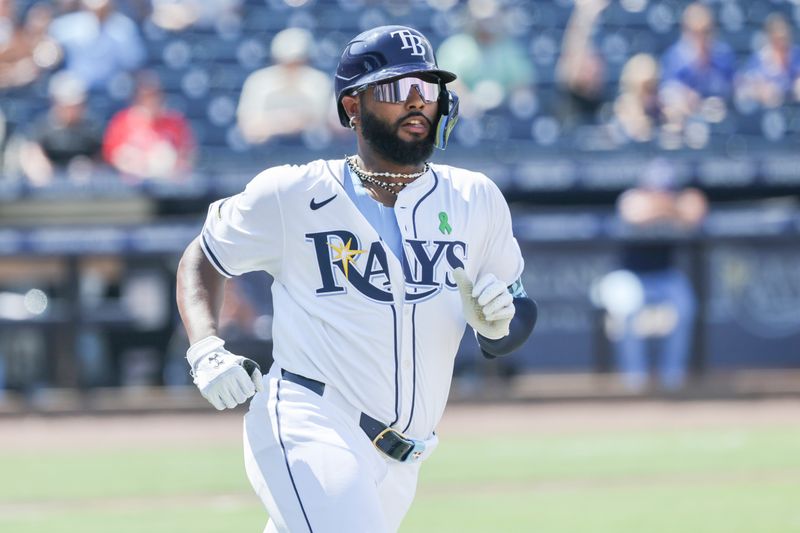 May 25, 2025; St. Petersburg, Florida, USA;  Tampa Bay Rays third base Junior Caminero (13) doubles during the seventh inning against the Toronto Blue Jays at George M. Steinbrenner Field. Mandatory Credit: Kim Klement Neitzel-Imagn Images