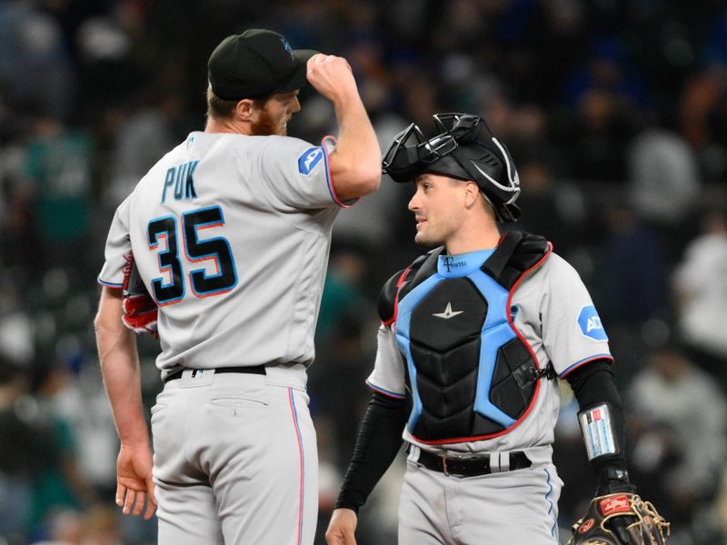 Jun 14, 2023; Seattle, Washington, USA; Miami Marlins catcher Nick Fortes (4) and relief pitcher A.J. Puk (35) stand on the mound defeating the Seattle Mariners at T-Mobile Park. Mandatory Credit: Steven Bisig-USA TODAY Sports