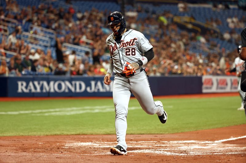 Apr 22, 2024; St. Petersburg, Florida, USA; Detroit Tigers shortstop Javier Báez (28) scores a run against the Tampa Bay Rays during the second inning at Tropicana Field. Mandatory Credit: Kim Klement Neitzel-USA TODAY Sports