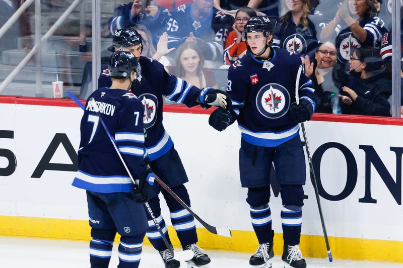 Sep 25, 2024; Winnipeg, Manitoba, CAN; Winnipeg Jets forward Brad Lambert (93) is congratulated by his teammates on his goal against the Edmonton Oilers during the third  period at Canada Life Centre. Mandatory Credit: Terrence Lee-Imagn Images