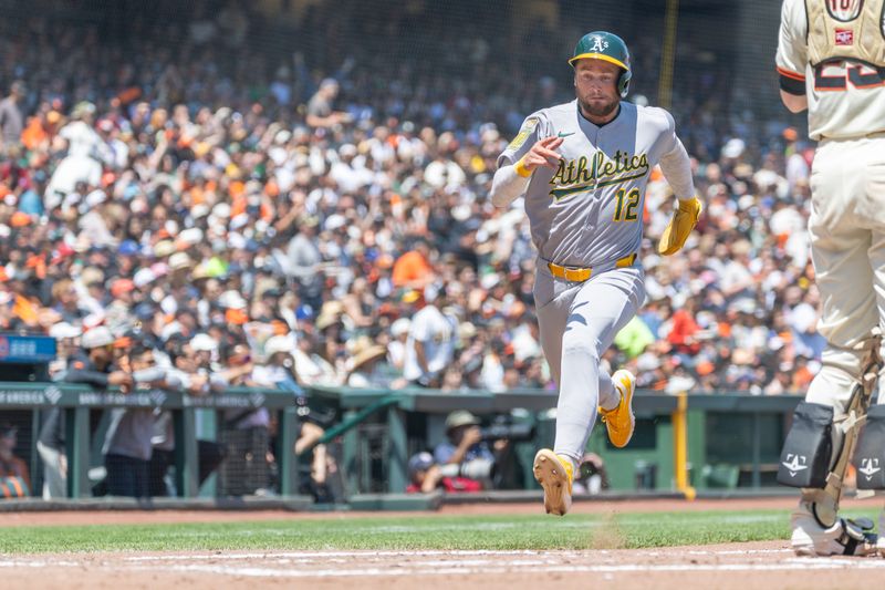 May 18, 2025; San Francisco, California, USA; Oakland Athletics third base Max Schuemann (12) comes home to score on a single from Oakland Athletics outfielder Lawrence Butler (4) during the fourth inning against the San Francisco Giants at Oracle Park. Mandatory Credit: Bob Kupbens-Imagn Images