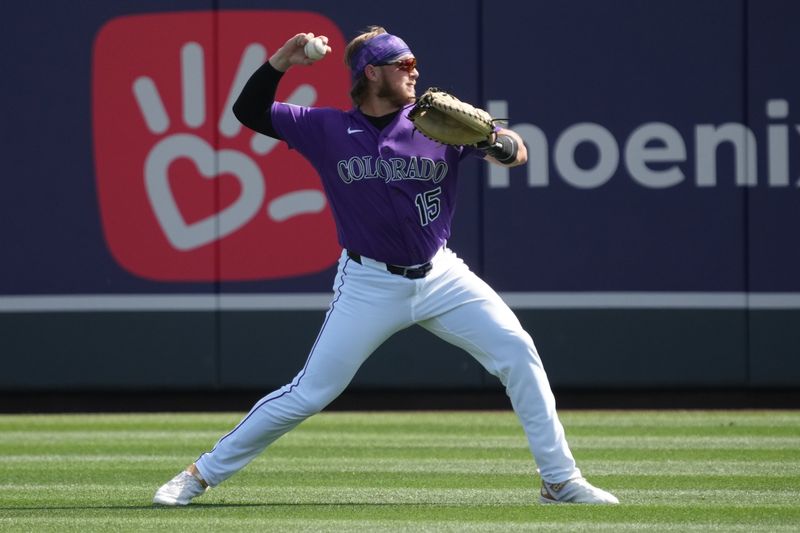 Mar 2, 2026; Salt River Pima-Maricopa, Arizona, USA; Colorado Rockies catcher Hunter Goodman (15) warms up before a game against the Los Angeles Dodgers at Salt River Fields at Talking Stick. Mandatory Credit: Rick Scuteri-Imagn Images