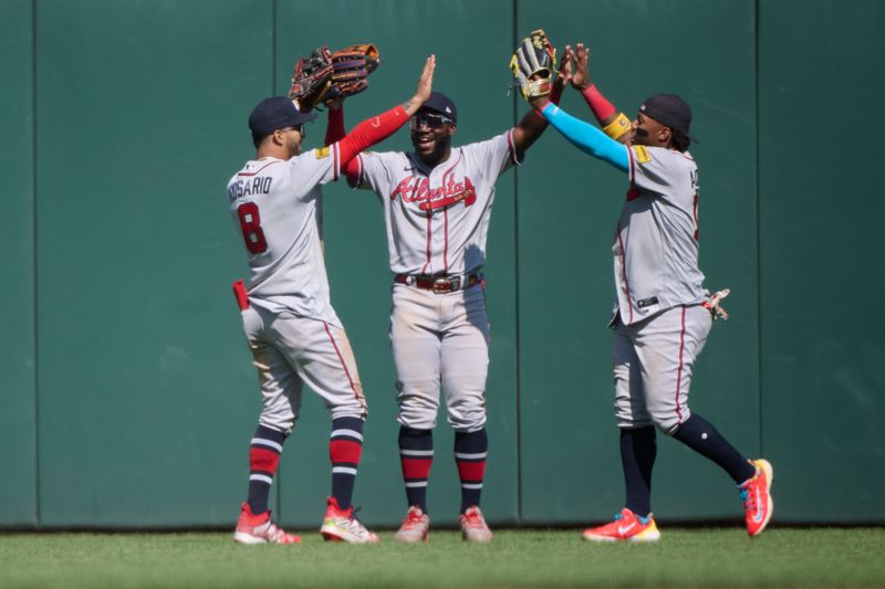 Aug 26, 2023; San Francisco, California, USA; Atlanta Braves outfielders Eddie Rosario (8) and Michael Harris II (23) and Ronald Acuna Jr. (13) celebrate in the outfield after the last out of the ninth inning against the San Francisco Giants at Oracle Park.  Mandatory Credit: Robert Edwards-USA TODAY Sports