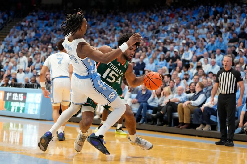 Feb 26, 2024; Chapel Hill, North Carolina, USA; Miami (Fl) Hurricanes forward Norchad Omier (15) with the ball as North Carolina Tar Heels forward Jae'Lyn Withers (24) defends in the first half at Dean E. Smith Center. Mandatory Credit: Bob Donnan-USA TODAY Sports