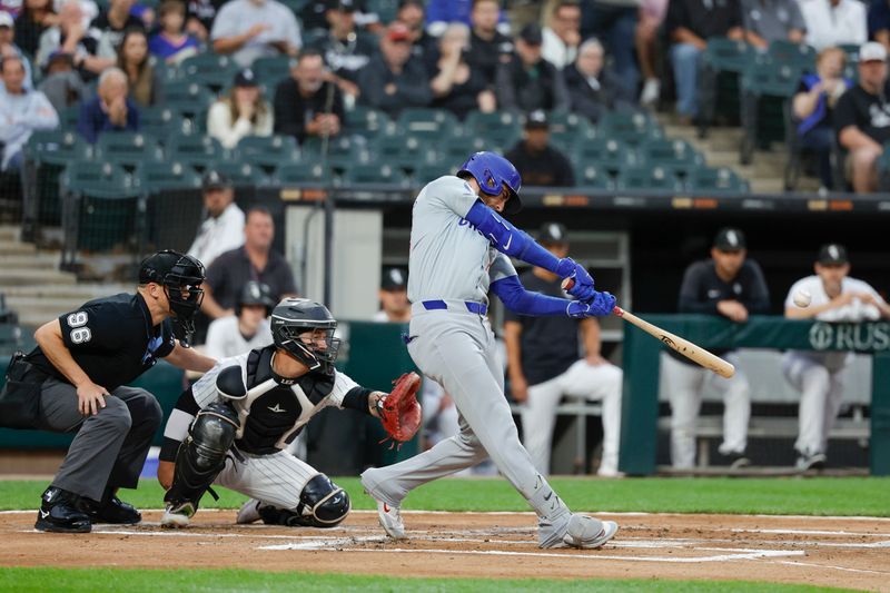 Aug 9, 2024; Chicago, Illinois, USA; Chicago Cubs outfielder Cody Bellinger (24) hits a two-run home run against the Chicago White Sox during the first inning at Guaranteed Rate Field. Mandatory Credit: Kamil Krzaczynski-USA TODAY Sports