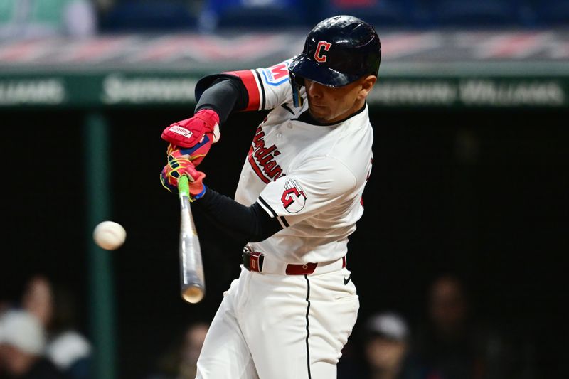 Apr 19, 2024; Cleveland, Ohio, USA; Cleveland Guardians second baseman Andres Gimenez (0) hits an RBI single during the fifth inning against the Oakland Athletics at Progressive Field. Mandatory Credit: Ken Blaze-USA TODAY Sports