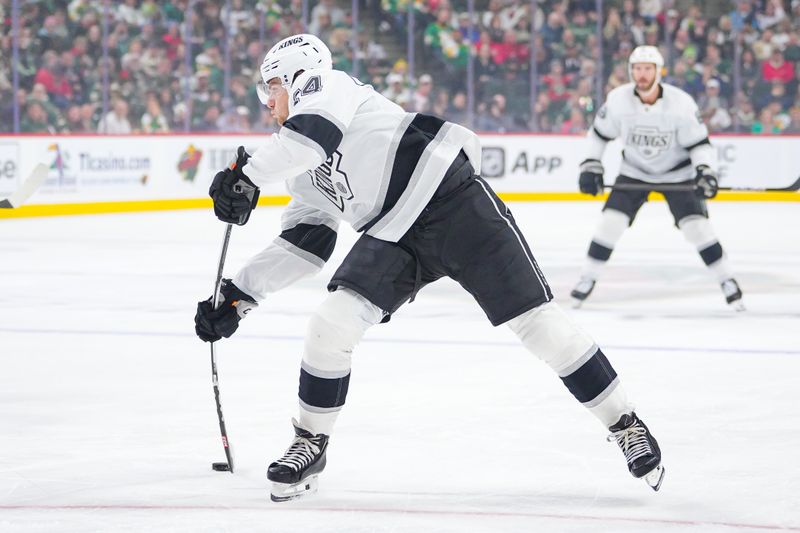 Nov 5, 2024; Saint Paul, Minnesota, USA; Los Angeles Kings center Phillip Danault (24) shoots against the Minnesota Wild in the first period at Xcel Energy Center. Mandatory Credit: Brad Rempel-Imagn Images