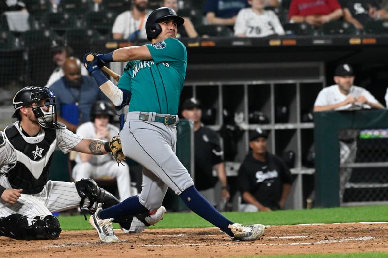 Aug 22, 2023; Chicago, Illinois, USA; Seattle Mariners third baseman Josh Rojas (4) hits a two run home run against the Chicago White Sox during the fourth inning at Guaranteed Rate Field. Mandatory Credit: Matt Marton-USA TODAY Sports