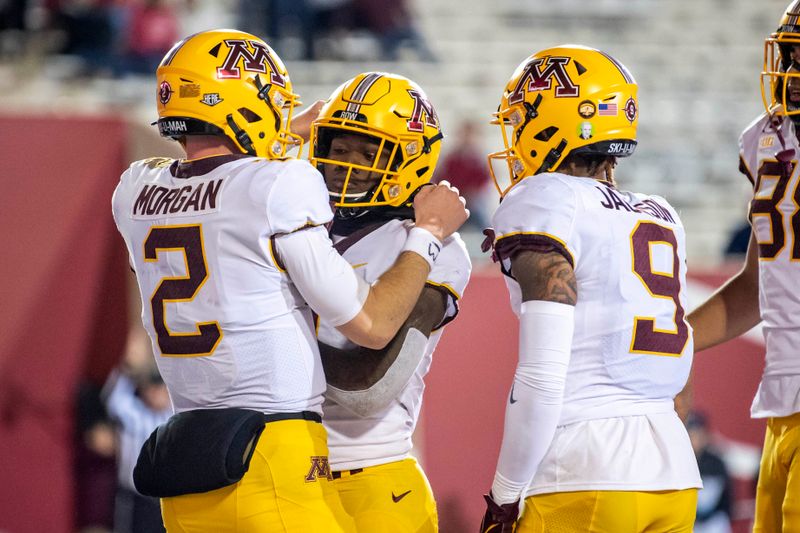 Nov 20, 2021; Bloomington, Indiana, USA;  Minnesota Golden Gophers quarterback Tanner Morgan (2) and Minnesota Golden Gophers running back Mar'Keise Irving (4) celebrate a touchdown during the second half at Memorial Stadium. Gophers won 35-14. Mandatory Credit: Marc Lebryk-USA TODAY Sports