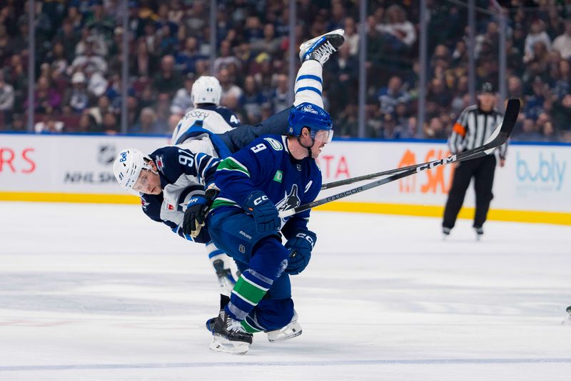 Feb 17, 2024; Vancouver, British Columbia, CAN; Winnipeg Jets forward Cole Perfetti (91) collides with Vancouver Canucks forward J.T. Miller (9) in the third period at Rogers Arena. Jets won 4-2. Mandatory Credit: Bob Frid-USA TODAY Sports