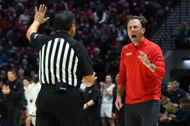 Jan 14, 2023; San Diego, California, USA; New Mexico Lobos head coach Richard Pitino (right) reacts toward an official during the second half against the San Diego State Aztecs at Viejas Arena. Mandatory Credit: Orlando Ramirez-USA TODAY Sports