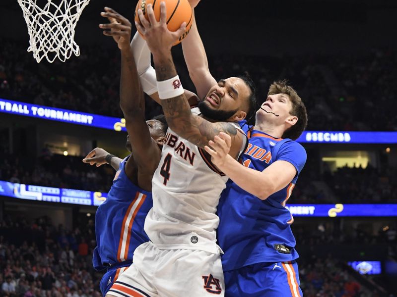 Mar 17, 2024; Nashville, TN, USA; Auburn Tigers forward Johni Broome (4) fights for a rebound against Florida Gators forward Alex Condon (21) in the first half in the SEC Tournament championship game at Bridgestone Arena. Mandatory Credit: Steve Roberts-USA TODAY Sports