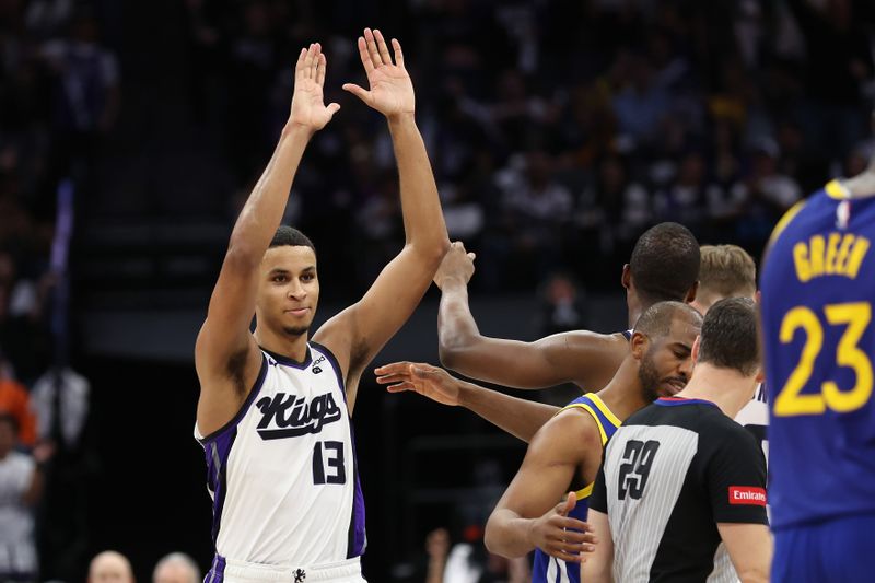 SACRAMENTO, CALIFORNIA - APRIL 16: Keegan Murray #13 of the Sacramento Kings is congratulated by De'Aaron Fox #5 and Domantas Sabonis #10 of the Sacramento Kings during their game against the Golden State Warriors in the second half during the Play-In Tournament at Golden 1 Center on April 16, 2024 in Sacramento, California.  NOTE TO USER: User expressly acknowledges and agrees that, by downloading and or using this photograph, User is consenting to the terms and conditions of the Getty Images License Agreement.  (Photo by Ezra Shaw/Getty Images)