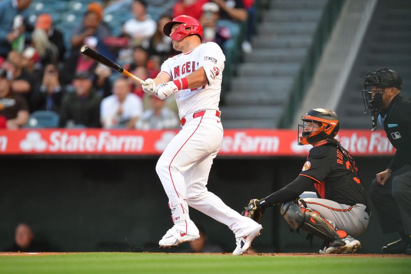 Apr 23, 2024; Anaheim, California, USA; Los Angeles Angels center fielder Mike Trout (27) hits a solo home run against the Baltimore Orioles during the first inning at Angel Stadium. Mandatory Credit: Gary A. Vasquez-USA TODAY Sports