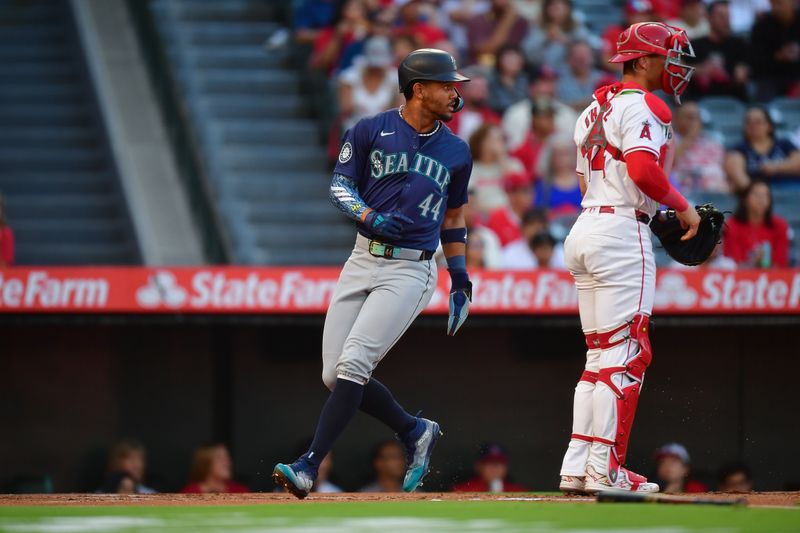 Aug 30, 2024; Anaheim, California, USA; Seattle Mariners center fielder Julio Rodríguez (44) scores a run against the Los Angeles Angels during the first inning at Angel Stadium. Mandatory Credit: Gary A. Vasquez-USA TODAY Sports
