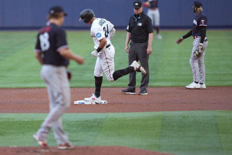 Apr 4, 2023; Miami, Florida, USA;  Miami Marlins right fielder Avisail Garcia (24) rounds the bases after hitting a home run in the second inning against the Minnesota Twins at loanDepot Park. Mandatory Credit: Jim Rassol-USA TODAY Sports