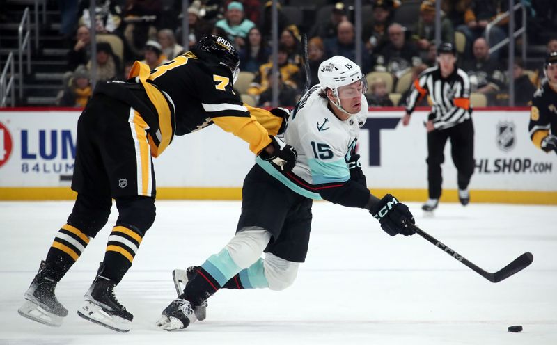 Jan 14, 2025; Pittsburgh, Pennsylvania, USA;  Pittsburgh Penguins defenseman P.O Joseph (73) commits a cross checking penalty against Seattle Kraken center John Hayden (15) during the second period at PPG Paints Arena. Mandatory Credit: Charles LeClaire-Imagn Images