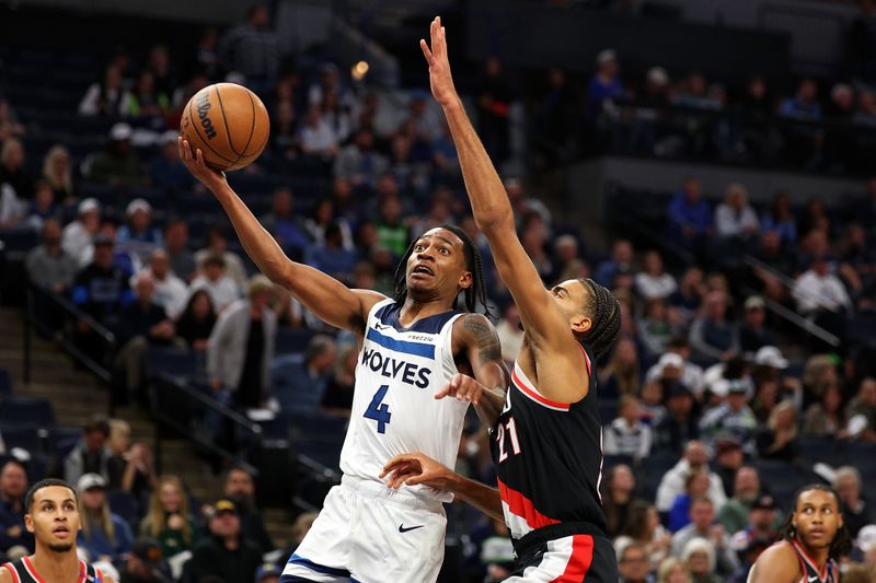 MINNEAPOLIS, MINNESOTA - NOVEMBER 08: Rob Dillingham #4 of the Minnesota Timberwolves goes up for a shot against Rayan Rupert #21 of the Portland Trail Blazers in the fourth quarter at Target Center on November 08, 2024 in Minneapolis, Minnesota. The Timberwolves defeated the Trail Blazers 127-102 NOTE TO USER: User expressly acknowledges and agrees that, by downloading and or using this photograph, User is consenting to the terms and conditions of the Getty Images License Agreement. (Photo by David Berding/Getty Images)