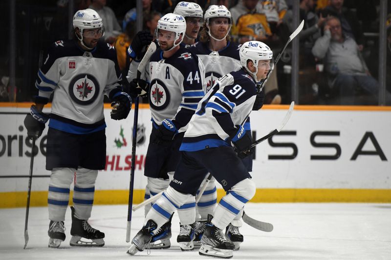 Nov 26, 2023; Nashville, Tennessee, USA; Winnipeg Jets center Cole Perfetti (91) is congratulated by teammates after a goal during the third period against the Nashville Predators at Bridgestone Arena. Mandatory Credit: Christopher Hanewinckel-USA TODAY Sports