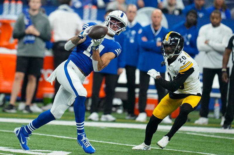 Indianapolis Colts wide receiver Michael Pittman Jr. (11) makes a catch in front of Pittsburgh Steelers cornerback Patrick Peterson (20) during an NFL football game in Indianapolis, Saturday, Dec. 16, 2023. The Colts defeated the Steelers 30-13. (AP Photo/Michael Conroy)