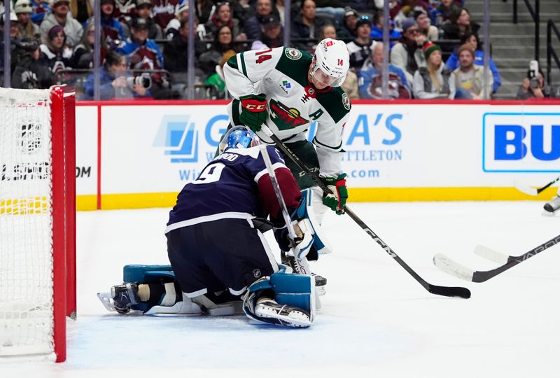 Jan 20, 2025; Denver, Colorado, USA; Colorado Avalanche goaltender Mackenzie Blackwood (39) makes a save on Minnesota Wild center Joel Eriksson Ek (14) in the first period at Ball Arena. Mandatory Credit: Ron Chenoy-Imagn Images