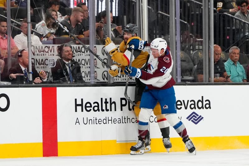 Oct 9, 2024; Las Vegas, Nevada, USA; Colorado Avalanche center Ross Colton (20) checks Vegas Golden Knights defenseman Nicolas Hague (14) during the second period at T-Mobile Arena. Mandatory Credit: Lucas Peltier-Imagn Images