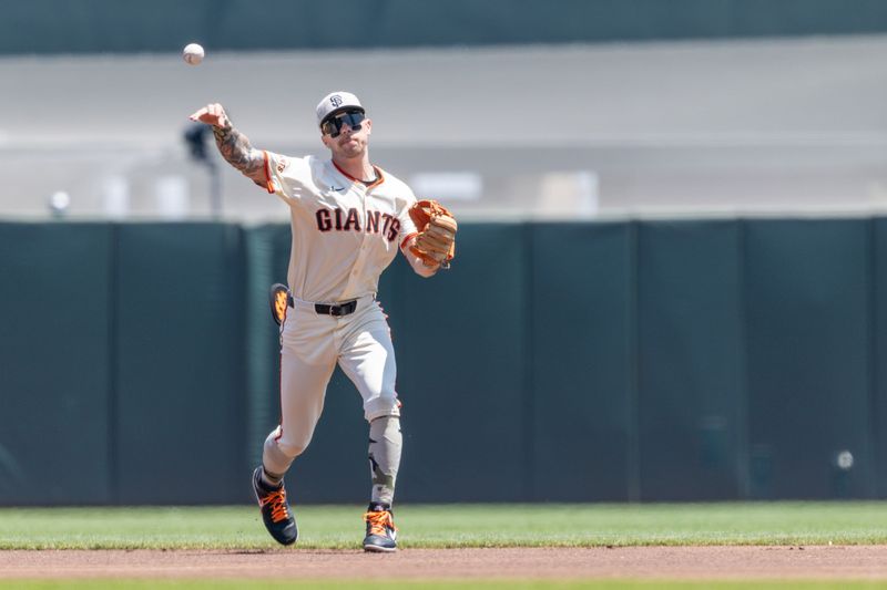 May 18, 2025; San Francisco, California, USA; San Francisco Giants second base Christian Koss (50) makes a play at first during the first inning against the Oakland Athletics at Oracle Park. Mandatory Credit: Bob Kupbens-Imagn Images