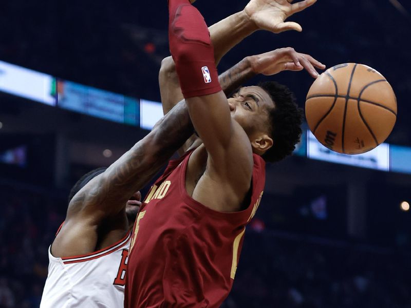 CLEVELAND, OH - FEBRUARY 14: Donovan Mitchell #45 of the Cleveland Cavaliers loses the ball against Torrey Craig #13 of the Chicago Bulls during the first half at Rocket Mortgage Fieldhouse on February 14, 2024 in Cleveland, Ohio. NOTE TO USER: User expressly acknowledges and agrees that, by downloading and or using this photograph, User is consenting to the terms and conditions of the Getty Images License Agreement. (Photo by Ron Schwane/Getty Images)