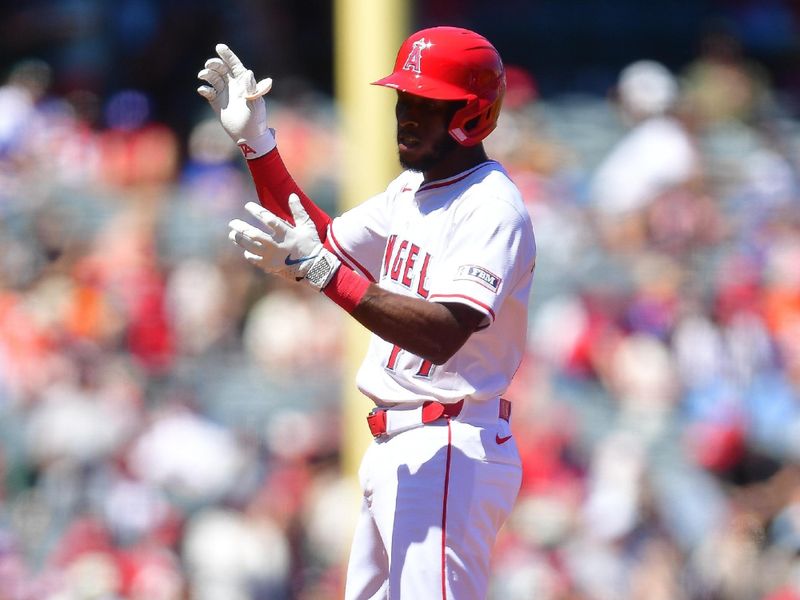 Apr 6, 2025; Anaheim, California, USA; Los Angeles Angels shortstop Tim Anderson (77) reaches second on an error by Cleveland Guardians left fielder Steven Kwan (38) during the second inning at Angel Stadium. Mandatory Credit: Gary A. Vasquez-Imagn Images