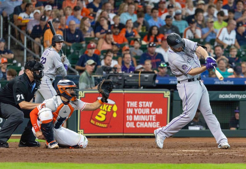 Jul 5, 2023; Houston, Texas, USA; Colorado Rockies designated hitter C.J. Cron (25) hits a home run against the Houston Astros in the sixth inning at Minute Maid Park. Mandatory Credit: Thomas Shea-USA TODAY Sports