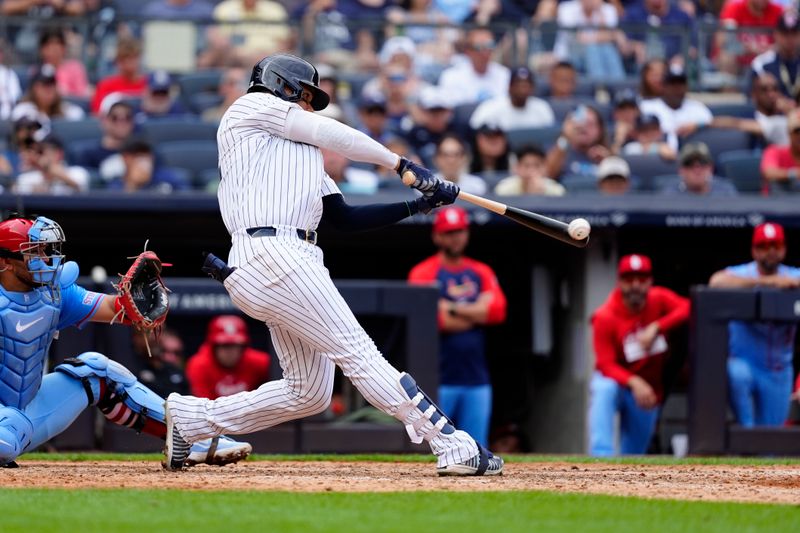 Aug 31, 2024; Bronx, New York, USA; New York Yankees right fielder Juan Soto (22) hits a double against the St. Louis Cardinals during the ninth inning at Yankee Stadium. Mandatory Credit: Gregory Fisher-USA TODAY Sports